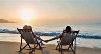 couple sitting in beach chairs on hold hands in front of a sunrise. The Caribbean. Hawaii Vacations for Couples: 8 Most Romantic Spots To Visit | Royal Caribbean Cruises A guide to Hawaii vacations for couples including where to go, what to do and how to amp up the romance on a Hawaiian cruise to the islands.