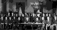 U.S. Pres. Calvin Coolidge (seated left) signing the Kellogg-Briand Pact, January 1929, Washington, D.C.