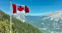 Free Canada Flag With Mountain Range View Stock Photo