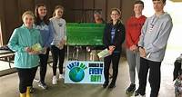 Students from the Haslett Middle School Conservation Club were at the Meridian Township Farmer's Market on May 18 to educate the community about improving recycling practices. The students planned, researched, and designed a brochure, which they used as a talking point with visitors to the market.