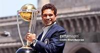 Sachin Tendulkar of the Indian cricket team poses with the ICC Cricket World Cup Trophy, with the Gateway of India in the backdrop, during a photo