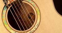 Sound hole of acoustic guitar with illustration of a man inside