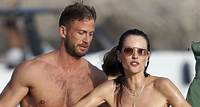 Alessandra Ambrosio sizzles in red hot bikini alongside hunky businessman Alexander Smurfit as they enjoy a swim in Ibiza - amid split rumors with Richard Lee