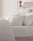 Bed with white pillows and bedding.