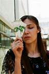 Free A woman holding a plant in her hand Stock Photo