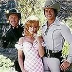 Kirk Douglas, Arnold Schwarzenegger, and Ann-Margret in The Villain (1979)