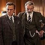 Sam Neill and Christoph Waltz in The Portable Door (2023)