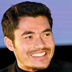 How did Henry Golding grow up?3