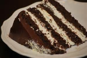 dark chocolate four layer cake filled with fluffy whipped cream and ...